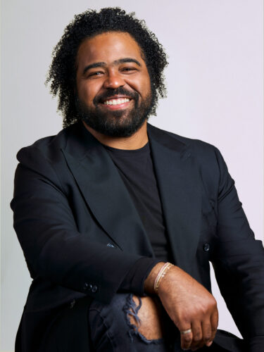 Man smiling in Black suit jacket and shirt